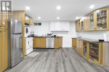 Fort Erie (Central) multi-family for rent - A modern kitchen with wooden cabinets and stainless steel appliances.
