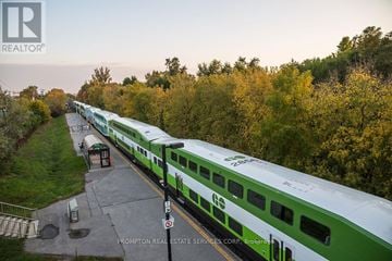 Toronto (Bayview Village) condo for rent - A green and white train is parked at a station.