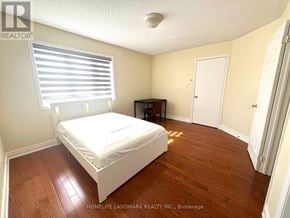 Markham (Milliken Mills East) apartment for rent - A bedroom with a bed, desk, and window.