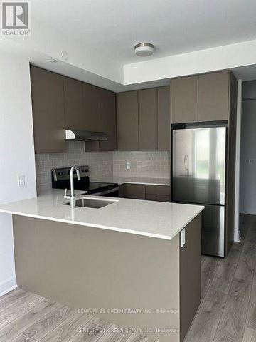 Oakville (Jm Joshua Meadows) condo for rent - A kitchen with a white counter top and brown cabinets.