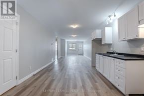 North Stormont apartment for rent - A long, narrow, white hallway with wood flooring and white cabinets on the wall.