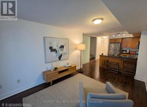 Toronto (Mount Pleasant West) condo for rent - A living room with a couch, a table, and a painting on the wall.