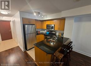 Toronto (Mount Pleasant West) condo for rent - A kitchen with wooden cabinets and a black counter top.