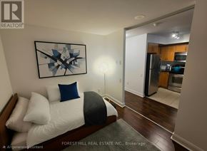 Toronto (Mount Pleasant West) condo for rent - A bedroom with a bed, pillows, and a framed picture on the wall.