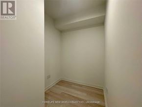 Toronto (Waterfront Communities) condo for rent - A room with white walls and wooden flooring.