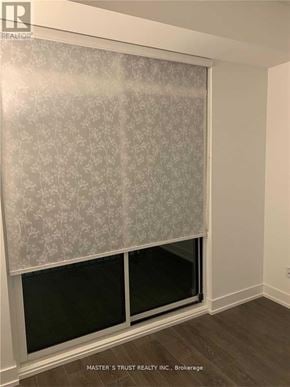 Markham (Unionville) condo for rent - A window with a grey patterned curtain in a room.