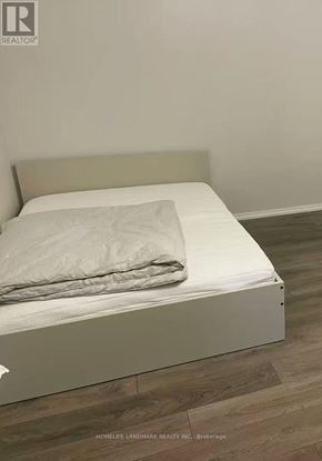 Toronto (Bay Street Corridor) condo for rent - A white bed with a white pillow and a white blanket.