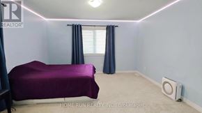 Ottawa apartment for rent - A bedroom with a purple bedspread and a window with blinds.