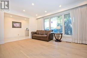 Toronto (Don Valley Village) apartment for rent - A living room with a brown couch and a painting on the wall.