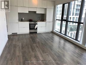 Toronto (Church-Yonge Corridor) condo for rent - A kitchen with white cabinets and a wood floor.