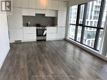 Toronto (Church-Yonge Corridor) condo for rent - A kitchen with white cabinets and a wood floor.