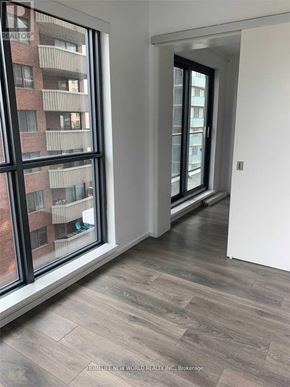 Toronto (Church-Yonge Corridor) condo for rent - A room with a large window and a view of a building across the street.