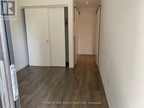 Toronto (Church-Yonge Corridor) condo for rent - A room with a white door and a wooden floor.