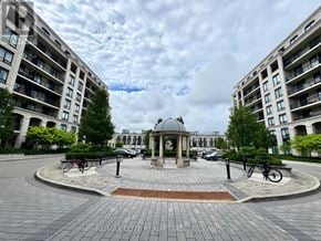 Markham (Unionville) condo for rent - A gazebo is surrounded by a brick walkway in the middle of a courtyard.