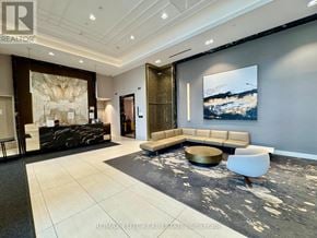 Markham (Unionville) condo for rent - A modern living room with a large painting on the wall and a black and white rug on the floor.