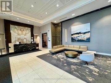 Markham (Unionville) condo for rent - A modern living room with a large painting on the wall and a black and white rug on the floor.