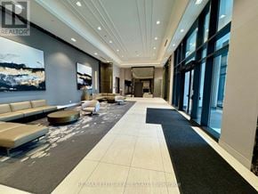 Markham (Unionville) condo for rent - A spacious lobby with a large painting on the wall and a reception desk.