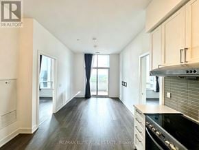 Markham (Unionville) condo for rent - A spacious kitchen with a stove top oven and a dining area with a table and chairs.