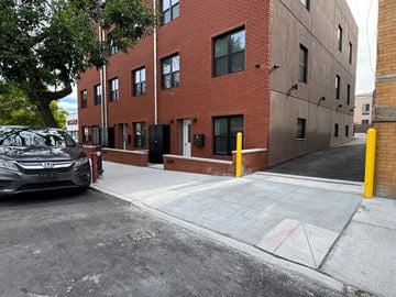Ridgewood apartment for rent - A black Honda car is parked on the side of a street.
