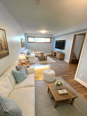 Guelph apartment for rent - A living room with a white couch and a wooden coffee table.