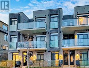 Toronto (Newtonbrook East) townhouse for rent - A modern apartment building with balconies and glass doors.