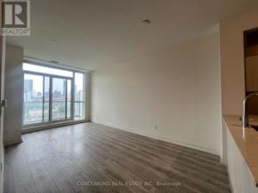 Toronto (Regent Park) condo for rent - A room with a large window and wooden flooring.
