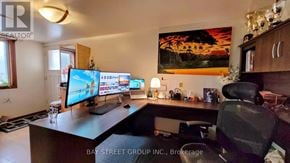 Toronto (Markland Wood) apartment for rent - A home office with a desk, computer, and a painting on the wall.