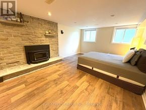 Toronto (Markland Wood) apartment for rent - A bedroom with a fireplace and a bed.