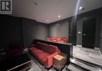 Ottawa condo for rent - A modern living room with a red couch and a black coffee table.