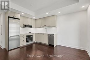 Ottawa condo for rent - A modern kitchen with white cabinets and stainless steel appliances.