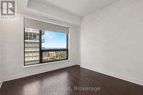 Ottawa condo for rent - A spacious room with a large window overlooking a cityscape.