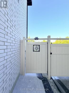 Pickering (Highbush) apartment for rent - A white gate with a black square design is closed.