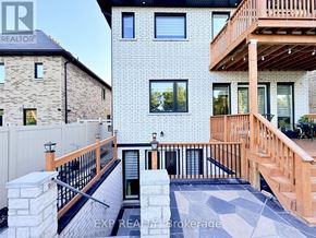 Pickering (Highbush) apartment for rent - A modern house with a balcony and a stone wall.