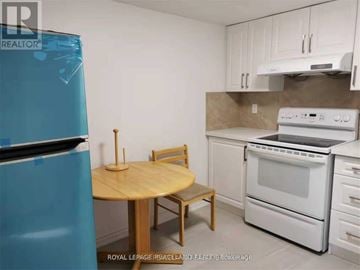 Toronto (Tam O'shanter-Sullivan) apartment for rent - A kitchen with a table and chairs and a fridge.