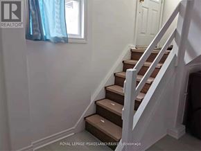 Toronto (Tam O'shanter-Sullivan) apartment for rent - A staircase with white railings and brown steps.