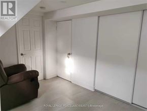 Toronto (Tam O'shanter-Sullivan) apartment for rent - A room with a brown couch and white walls.