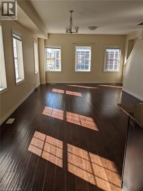 Kitchener townhouse for rent - A room with wooden floors and windows.