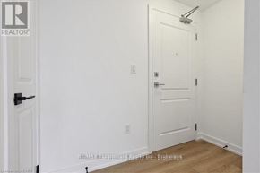 Hamilton (Waterdown) condo for rent - A white door is in a room with white walls.