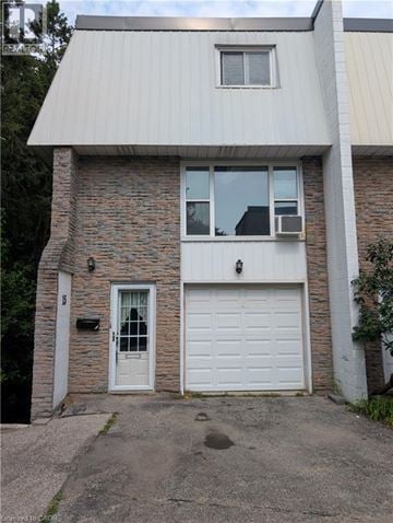 Kitchener townhouse for rent - A house with a white garage door and a grey roof.