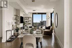 Toronto (Forest Hill South) condo for rent - A modern dining room with a table set for two and a view of the city.
