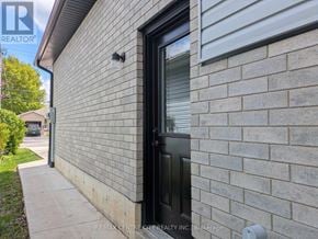 Aylmer fourplex for rent - A house with a black door and a brick wall.