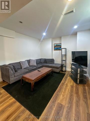 Mississauga (Lisgar) apartment for rent - A living room with a grey couch and a wooden coffee table.