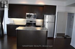 Mississauga (City Centre) condo for rent - A kitchen with a refrigerator, oven, and microwave.