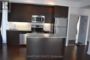 Mississauga (City Centre) condo for rent - A kitchen with dark brown cabinets and stainless steel appliances.