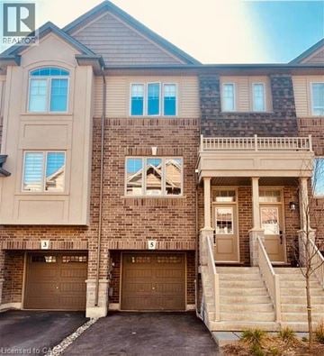 Ancaster townhouse for rent - A two-story brick house with a garage on the ground floor.