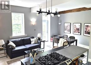 West Grey apartment for rent - A modern living room with a dark blue couch and a black gas stove.