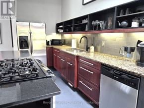 West Grey apartment for rent - A kitchen with a stove top oven and a refrigerator.