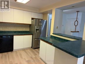 Guelph (Kortright West) apartment for rent - A kitchen with white cabinets and a green counter top.