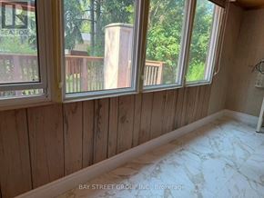 Toronto (Woburn) apartment for rent - A room with wooden walls and marble flooring.