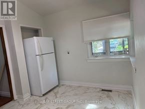 Toronto (Woburn) apartment for rent - A white refrigerator in a kitchen with marble flooring.